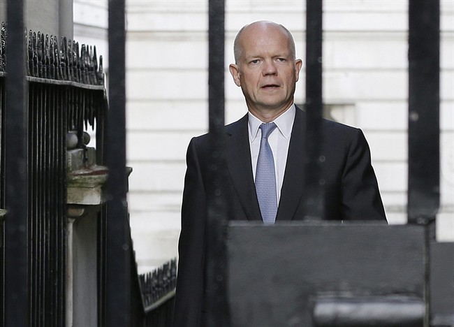 Britain' Foreign Secretary William Hague walks to Downing Street ahead of a national security meeting to be held at the Cabinet office with Prime Minister David Cameron on the situation in Syria, in London, Wednesday, Aug. 28, 2013.