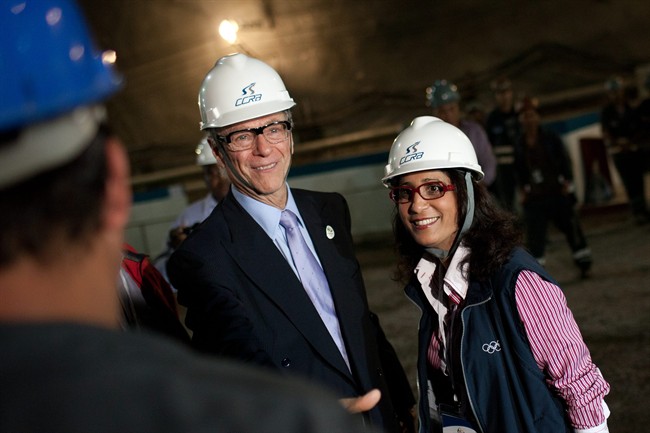 In this June 5, 2012 file photo, Nawal El Moutawakel, head of the IOC Evaluation Commission, right, and Brazil Olympic Committee President Carlos Arthur Nuzman, center, speak to workers at a subway construction site during the 3rd meeting of the IOC Coordination Commission for the Rio Olympics 2016, in Rio de Janeiro, Brazil. 