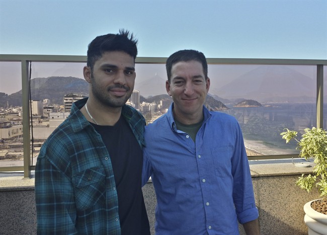In this undated photo released by Janine Gibson of The Guardian, Guardian journalist Glenn Greenwald, right, and his partner David Miranda, are shown together at an unknown location. 