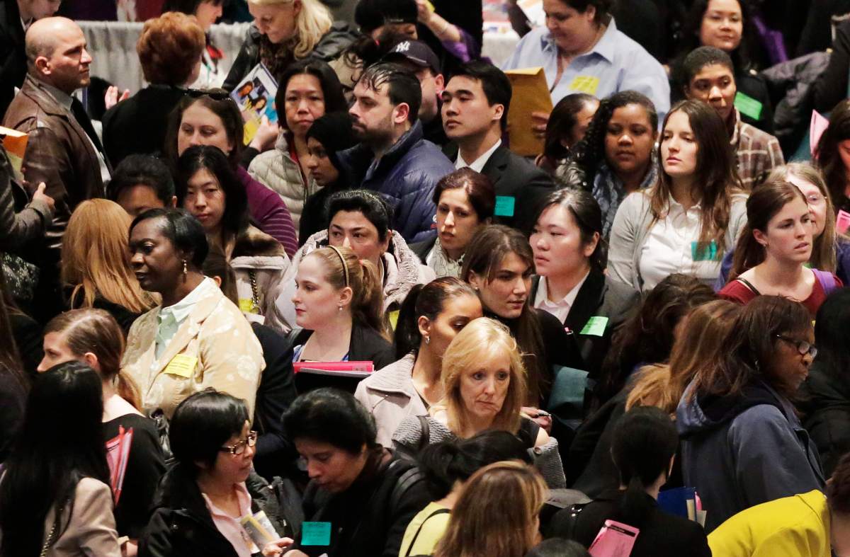 FILE - In this Thursday, March 14, 2013, file photo, a crowd of job seekers attends a health care job fair, in New York.