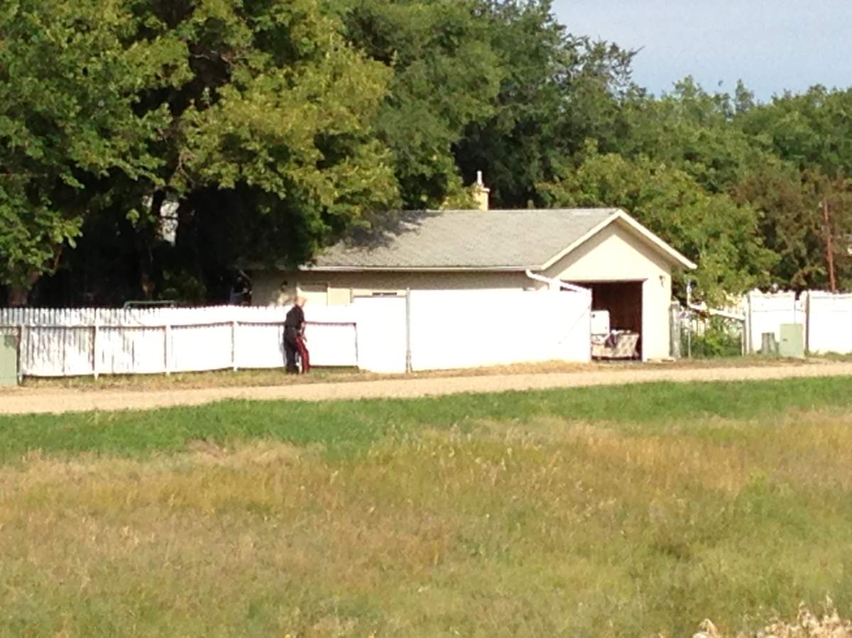 Regina Police secure the perimeter of a home on the 3100 Block of 6th Ave. N Tuesday morning.