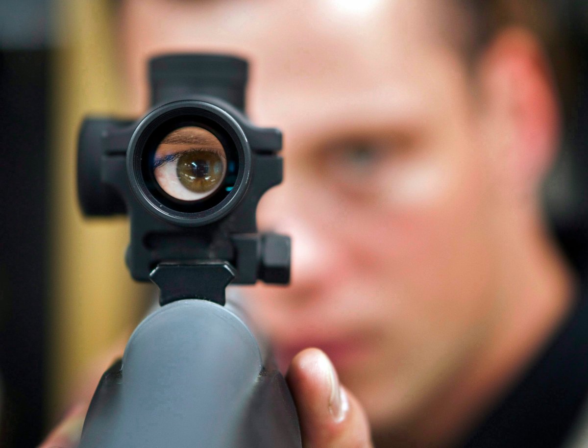 Patrick Deegan, a senior range officer at the Shooting Edge, looks through the scope of long gun at the store in Calgary, Wednesday, Sept. 15, 2010. 