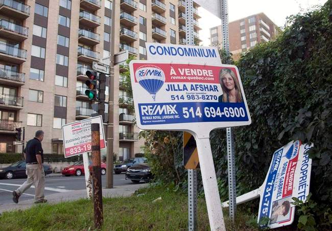 For sale signs stand in front of a condominium Tuesday, September 27, 2011 in Montreal. 