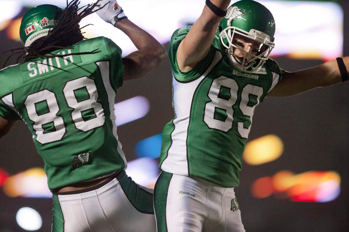 Saskatchewan Roughriders wide receiver Taj Smith celebrates Saskatchewan Roughriders slotback Chris Getzlaf's touchdown against the Toronto Argonauts during the second quarter of CFL football action in Regina, Sask., Saturday, September 14, 2013.