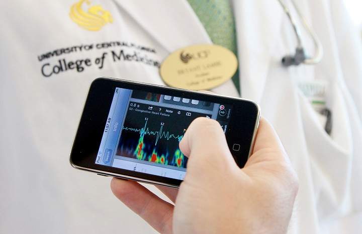 File -- Lynn McGrath, 25, UCF medical student, uses a medical app he downloaded to his iPod Touch, October 11, 2010. 