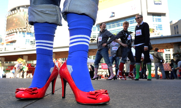 Groups of men take part in the White Ribbon Campaign to Walk A Mile in Her Shoes at Yonge-Dundas Square on Sept. 27, 2012.