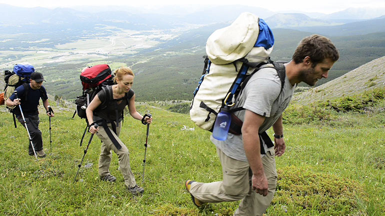 16x9 reporter Carolyn Jarvis sets out with Nick Vieira (right) and Damien Briguet to climb up the mountain to Booming Ice Chasm.