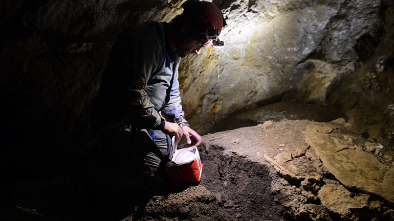 Nick Vieira takes soil samples in Booming Ice Chasm