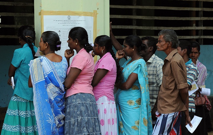 Sri Lankan ethnic Tamils wait in line to cast their votes at a polling station during the northern provincial council election in Jaffna, 400 kilometres (250 miles) north of the capital Colombo on September 21, 2013. Sri Lanka's minority Tamils began voting in an election they hope will give them a shot at self-rule after decades of ethnic bloodshed that claimed over 100,000 lives.