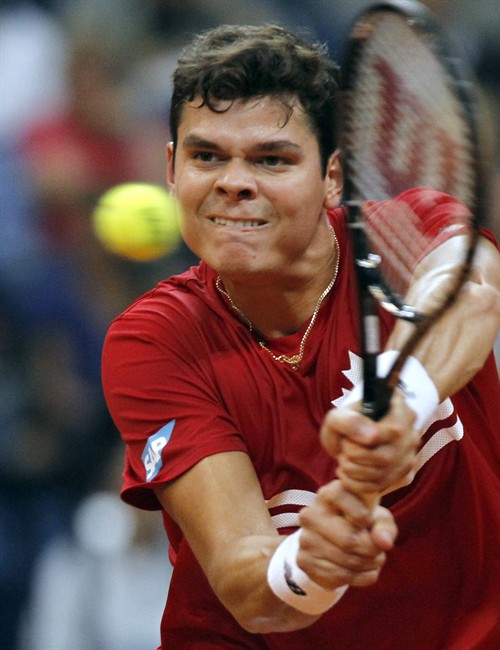 Milos Raonic of Canada returns a ball to Janko Tipsarevic of Serbia during their Davis Cup semifinal tennis match in Belgrade, Serbia, Friday, Sept. 13, 2013. 