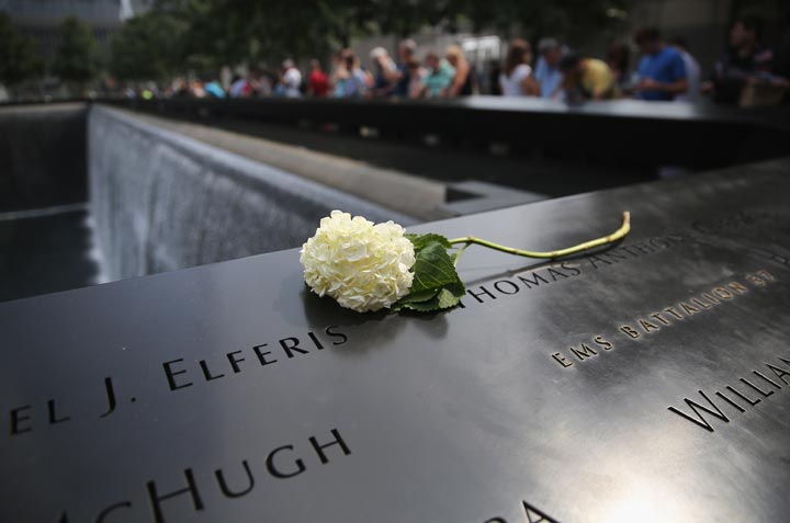A flower lies atop names of victims at the 9/11 Memorial on September 10, 2013 in New York City. 