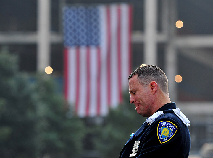  Daniel Henry, a Port Authority of New York/New Jersey police officer, pauses during a moment of silence at 9:01 am EDT, at the South reflecting pool of the 9/11 Memorial during ceremonies for the twelfth anniversary of the terrorist attacks on lower Manhattan at the World Trade Center site on September 11, 2013 in New York City. 