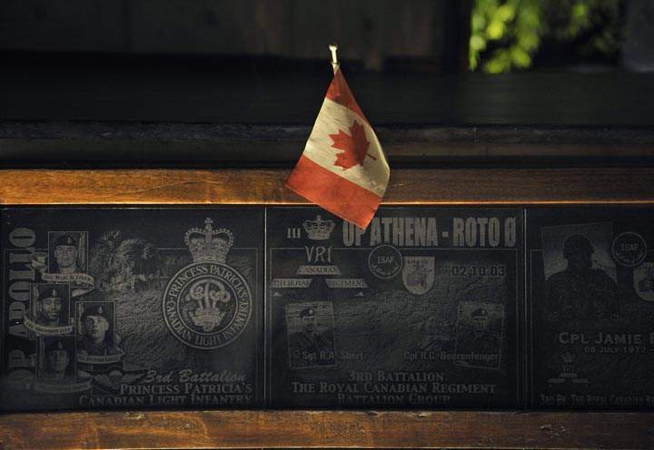 In this photograph taken on July 17, 2011 a Canadian flag is placed on a memorial marker honouring Canadian soldiers who died in combat in Afghanistan erected inside the Canadian forces quarters in Kandahar military base in southern Afghanistan. 