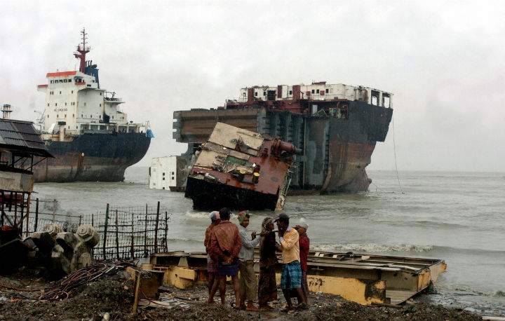 In this picture taken on July 29, 2008, Bangladeshi labourers work infront of docked ships at a shipbreaking yard in Sitakundu, on the outskirts of Chittagong. Bangladesh’s High Court has given the country’s 36 ship-breaking yards two weeks to cease work because of their failure to fulfil environmental regulations, a lawyer said March 18, 2009. (Photo: Farjana Khan Godhuly/AFP/Getty Images)