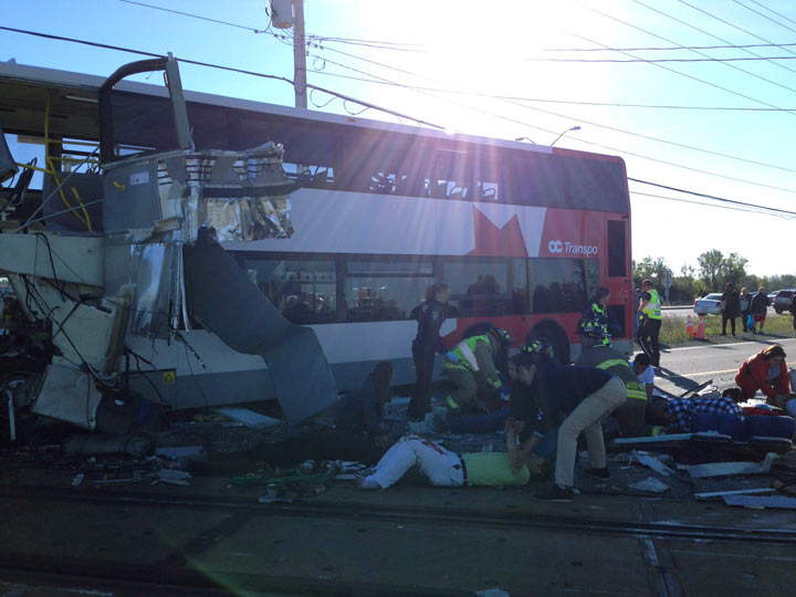 People are helped following a Via Rail train and a city bus collision in Ottawa’s west end Wednesday, Sept. 18, 2013. (Photo credit: THE CANADIAN PRESS/Terry Pedwell)