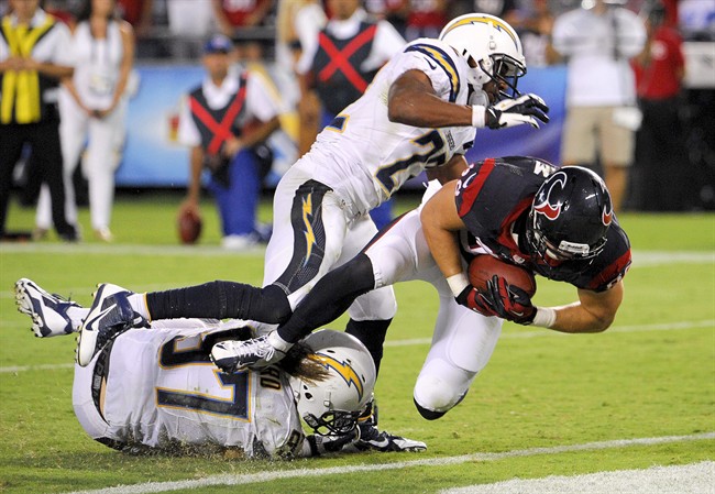 Houston Texans tight end Garrett Graham, right, scores between San Diego Chargers linebacker Bront Bird, left, and running back Ronnie Brown during the second half of an NFL football game.