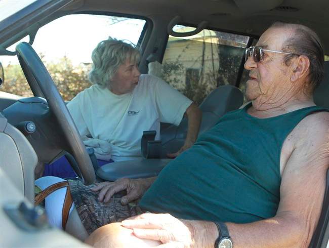 Frank Griffith and his wife, Kaye, wait in their truck in Igo, Calif. on Tuesday, Sept. 10, 2013. They spent Monday night in the truck after fleeing the Clover Fire in the Happy Valley area of Shasta County. Griffith and his wife have been unable to return to their home off Small Farms Road due to an evacuation order. Their home was destroyed. (Greg Barnette, AP Photo/Record Searchlight)