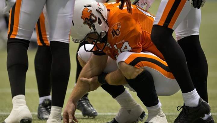 B.C. Lions' quarterback Travis Lulay holds his arm in pain after rushing for a touchdown during the second half of a CFL football game against the Montreal Alouettes in Vancouver on September 15, 2013. About all Corey Chamblin knows for sure is the Saskatchewan Roughriders won't have to deal with quarterback Travis Lulay when they face the B.C. Lions on Sunday. But who'll replace Lulay under centre? Well, that's another matter. THE CANADIAN PRESS/Darryl Dyck