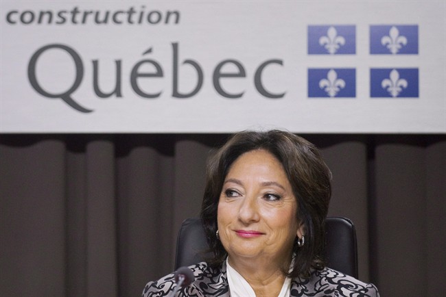 Justice France Charbonneau smiles as she sits on the opening day of a Quebec inquiry looking into allegations of corruption in the province's construction industry in Montreal, Tuesday, May 22, 2012.