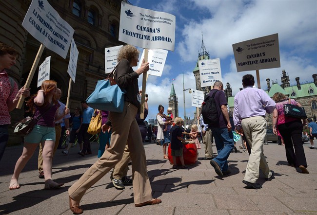 Canadian foreign service officers picket the Prime Minister's office in Ottawa, July 30, 2013. 