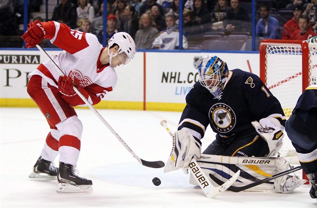 Detroit Red Wings centre Cory Emmerton, left, scores against St. Louis Blues goaltender Brian Elliott during the second period of their NHL hockey game on Feb. 7, 2013, in St. Louis. Thirty-seven players were placed on waivers around the NHL, including Leafs defenceman John-Michael Liles, Detroit Red Wings forward Emmerton, Winnipeg Jets defenceman Adam Pardy and Chicago Blackhawks defenceman Ryan Stanton.