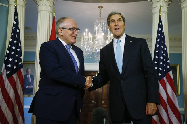 Secretary of State John Kerry and Dutch Foreign Minister Frans Timmermans shake hands after they made statements to reporters about efforts to disarm Syria of their chemical weapons at the State Department in Washington, Friday, Sept. 20, 2013. 