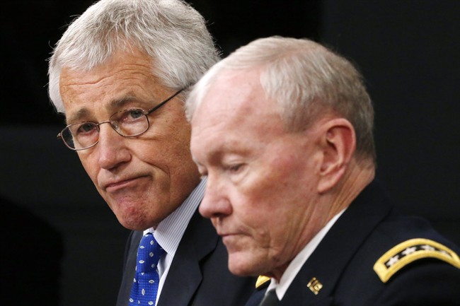 Defense Secretary Chuck Hagel and Chairman of the Joint Chiefs of Staff Gen. Martin Dempsey speak during a press conference at The Pentagon, Wednesday, Sept. 18, 2013. Hagel is ordering the Pentagon to review the physical security of all U.S. defense facilities worldwide and the security clearances that allow access to them. Hagel ordered the reviews in response to Monday's shooting rampage at the Washington Navy Yard, where a dozen people were killed. The shooter, Aaron Alexis, also was killed.