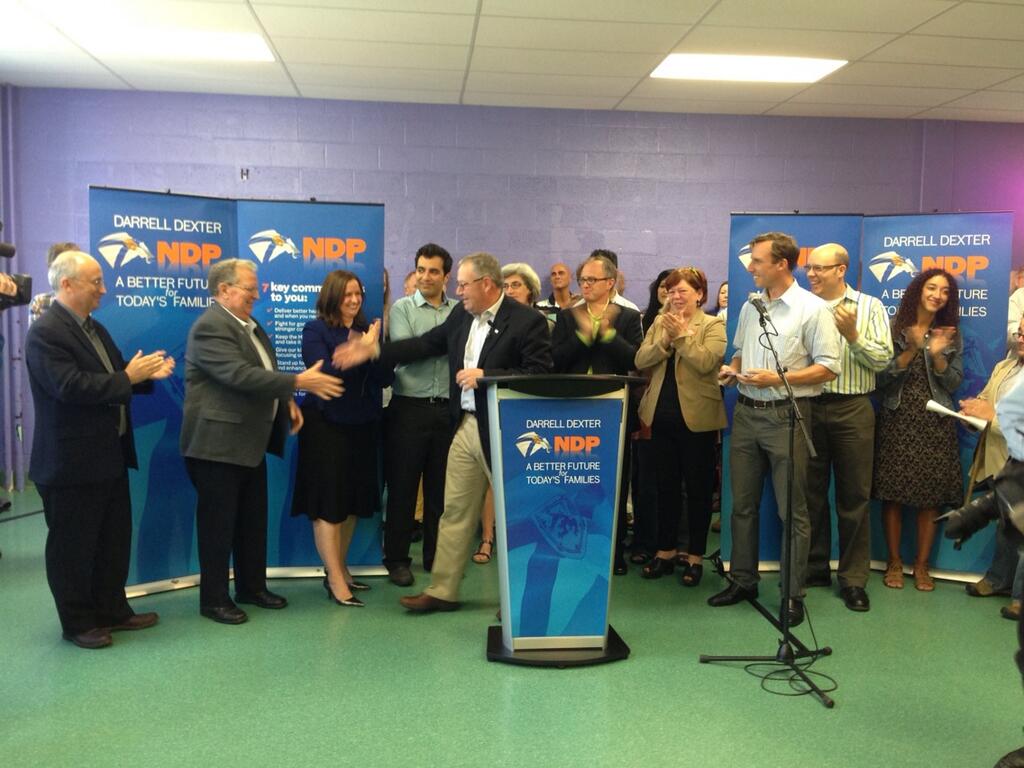 Darrell Dexter shakes hands at an announcement of his party's election platform.