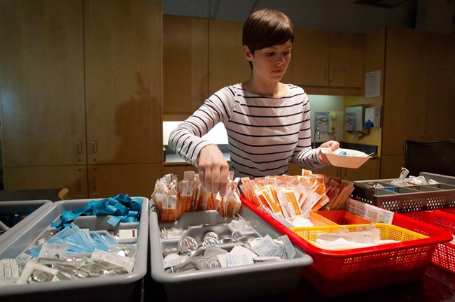 In this May 11, 2011 photo, registered nurse Sammy Mullally prepares a tray of supplies at the Insite safe injection clinic in Vancouver. 