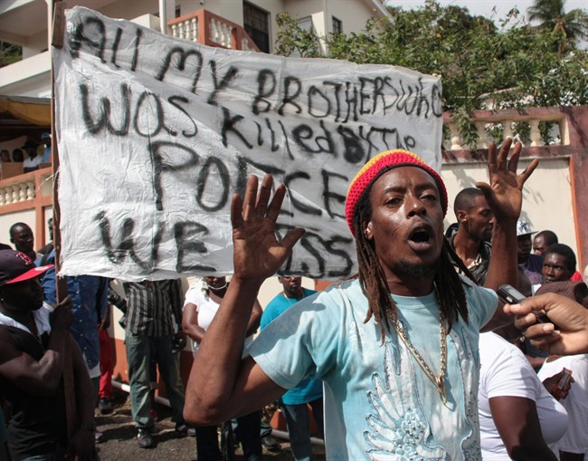 Protestors demonstrate after the five police officers charged with beating a Toronto man to death were granted bail on in a Jan. 6, 2012 file photo, St.David's, Grenada. 