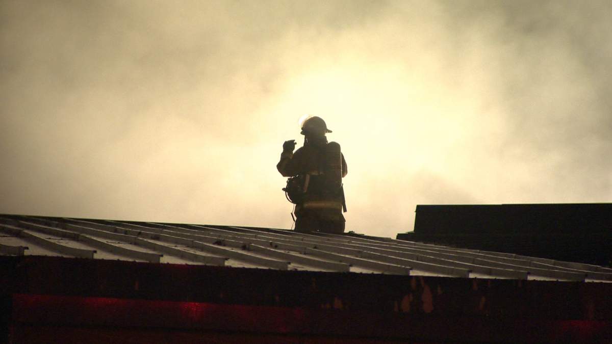 A Halifax firefighter investigates smoke on the roof of the Dartmouth Sportsplex on  Monday, September 30, 2013. 