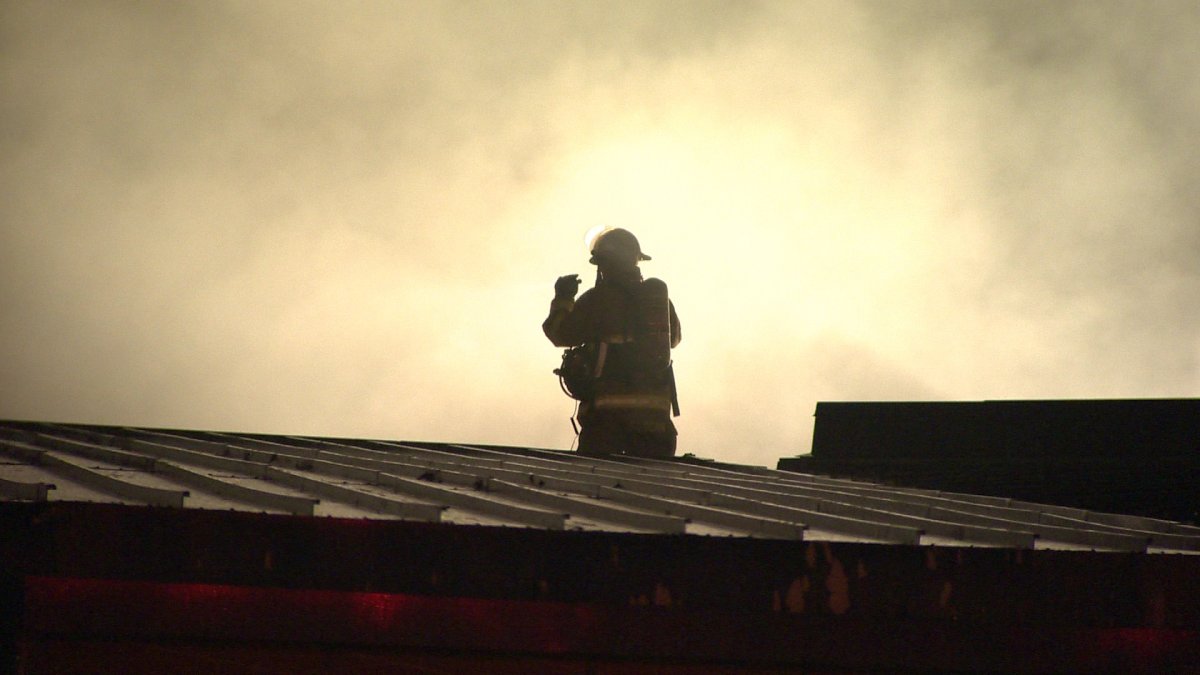 A Halifax firefighter investigates smoke on the roof of the Dartmouth Sportsplex on  Monday, September 30, 2013. 