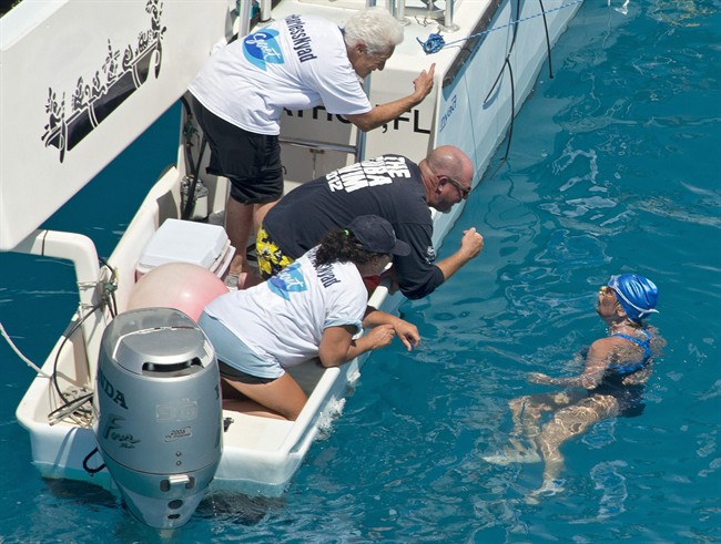 In this photo provided by the Florida Keys News Bureau, swimmer Diana Nyad talks with her crew less than two miles off Key West, Fla., Monday, Sept. 2, 2013.