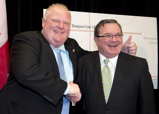 Federal Finance Minister Jim Flaherty (right) and Toronto Mayor Rob Ford shake hands after announcing funding of a subway line extension in Toronto on Monday September 23, 2013.
