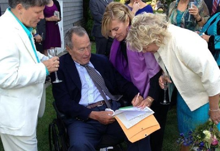 Former President George H.W. Bush signs a marriage license as an official witness at the same-sex wedding of two longtime friends.