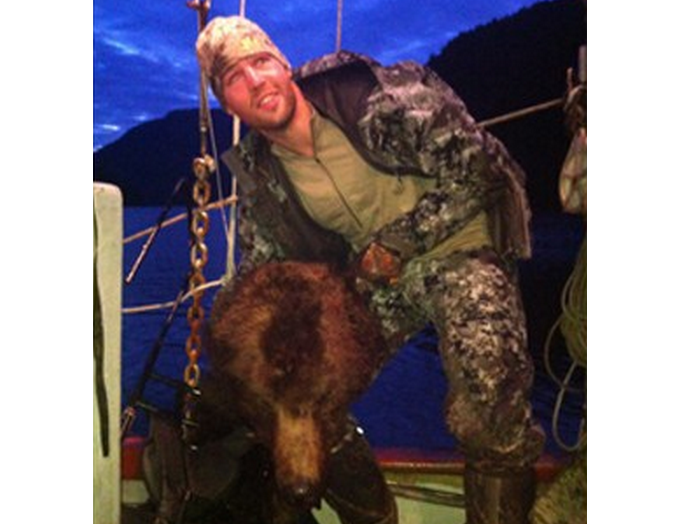 Clayton Stoner, an NHL player for the Minnesota Wild, has confirmed he is the person holding up a grizzly bear head in this photo taken in May and released to media on September 3. 