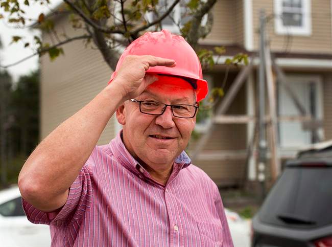 Premier Darrell Dexter adjusts his hard hat as he tours new house construction during a campaign stop in Halifax on Thursday, Sept. 12, 2013. Dexter announced a home ownership assistance program to help young graduates purchase their first home. The provincial election is on October 8. 