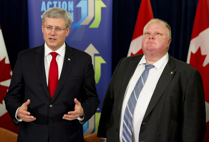 Prime Minister Stephen Harper speaks as Toronto Mayor Rob Ford, right, looks on, after announcing funding for new subways in Toronto, Sunday, September 22, 2013. 