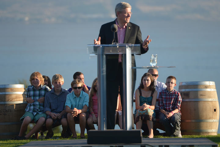 A group of children listen as Prime Minister Stephen Harper speaks at a member's BBQ at Quail's Gate, Okanagan Estate Winery in West Kelowna B.C., on Friday, Sept. 13, 2013.THE CANADIAN PRESS/Jonathan Hayward.
