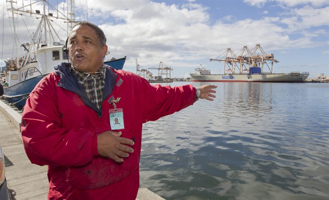 John Hernandez of Kailua, Hawaii and owner of John's Fresh Fish, gestures as he describes the effect of the spilled molasses will have on the marine like in Honolulu Harbor and near by Keehi Lagoon Thursday, Sept. 12, 2013, in Honolulu.