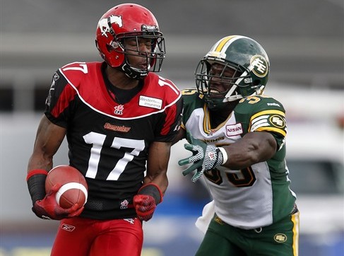 Edmonton Eskimos' Rennie Curran (right) tries to catch Calgary Stampeders' Maurice Price during second half CFL football action in Calgary, Alta., Monday, Sept. 2, 2013.