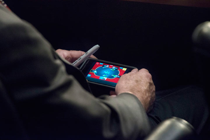 Senator John McCain plays poker on his IPhone during a U.S. Senate Committee on Foreign Relations hearing on Syria.