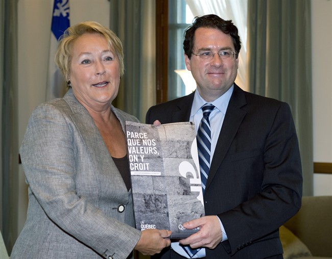 Quebec Premier Pauline Marois receives the tables Charter of Quebec values from Minister Responsible for Democratic Institutions and Active Citizenship Bernard Drainville Tuesday, September 10, 2013 at the legislature in Quebec City.