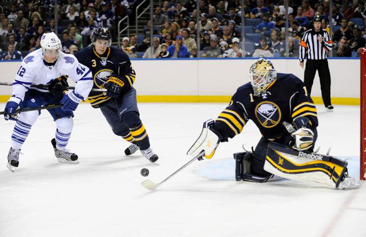 Toronto Maple Leafs' Tyler Bozak (42) and Buffalo Sabres' Mark Pysyk (3) watch as Sabres' Jhonas Enroth  (1) knocks the puck away during the second period of an NHL hockey preseason game in Buffalo, N.Y., Saturday, Sept. 21, 2013.