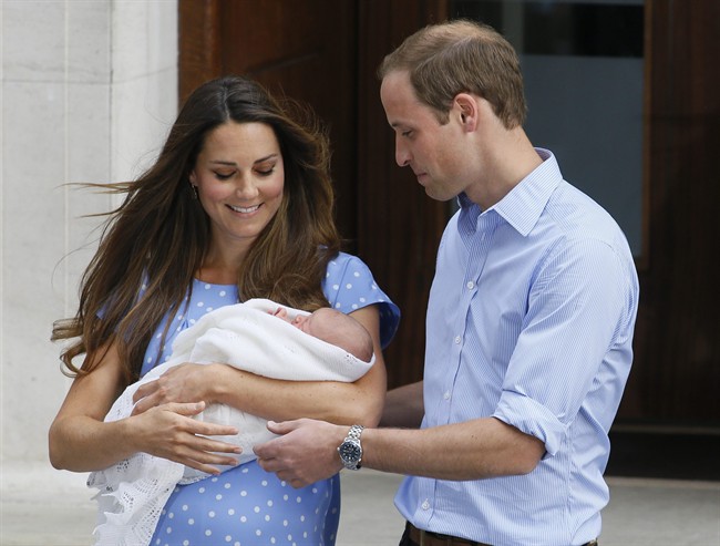 Britain’s Prince William, right, and Kate, Duchess of Cambridge hold the Prince of Cambridge, on Tuesday July 23, 2013.