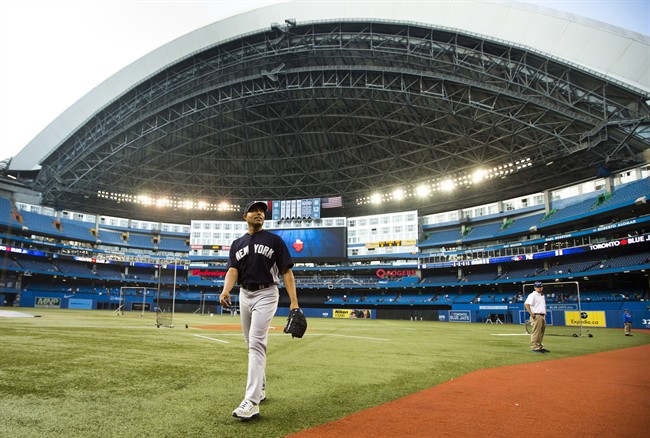 New York Yankees closer Mariano Rivera walks on the field in the Rogers Centre before his team plays the Toronto Blue Jays in MLB American League baseball action in Toronto, Thursday September 19, 2013. 