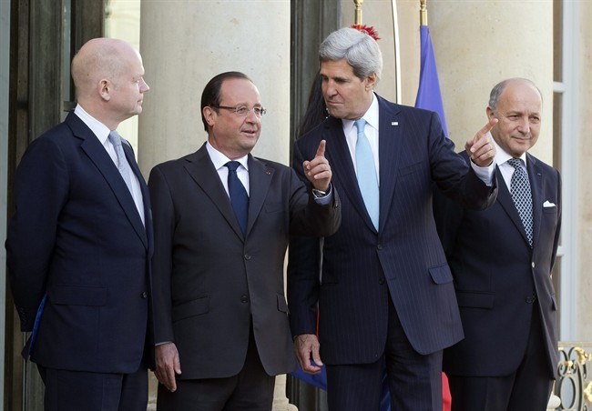 From left, British Foreign Secretary William Hague, French President Francois Hollande, U.S. Secretary of State John Kerry and French Foreign Minister Laurent Fabius pose upon their arrival at the Elysse Palace in Paris, prior to a meeting on Syria, Monday, Sept. 16, 2013. (AP Photo/Michel Euler).