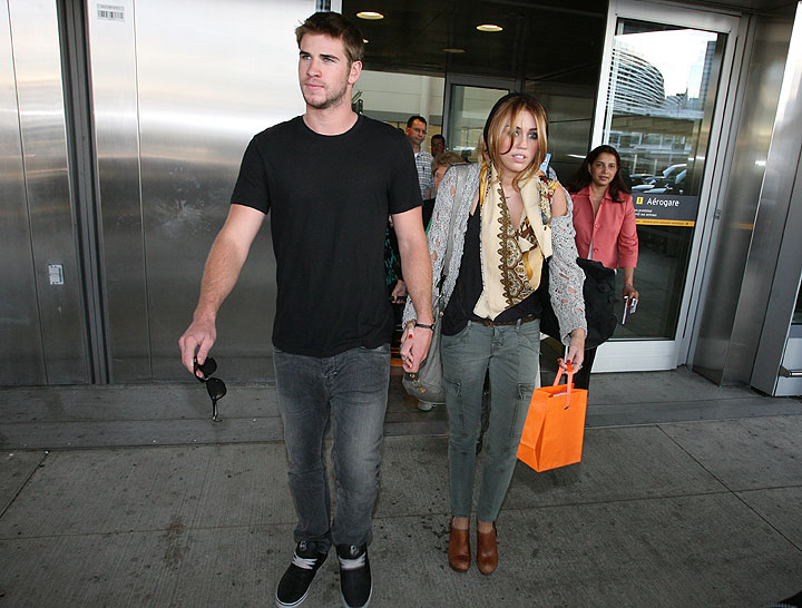 Liam Hemsworth and Miley Cyrus arrive at the Toronto airport in June 2010.