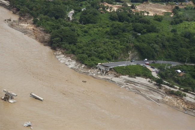 A bridge is collapsed along the Guadalupe River near the town of Lomas de Chapultepec, Mexico, Friday, Sept. 20, 2013. 