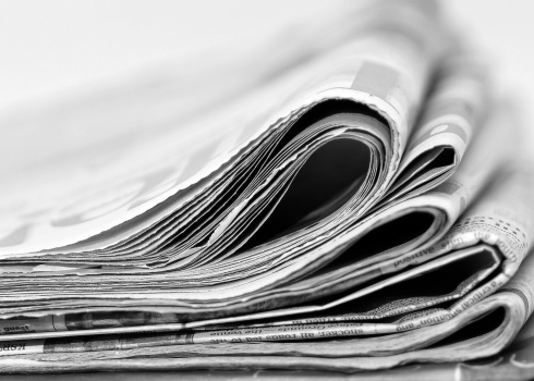 A stack of newspapers, information.